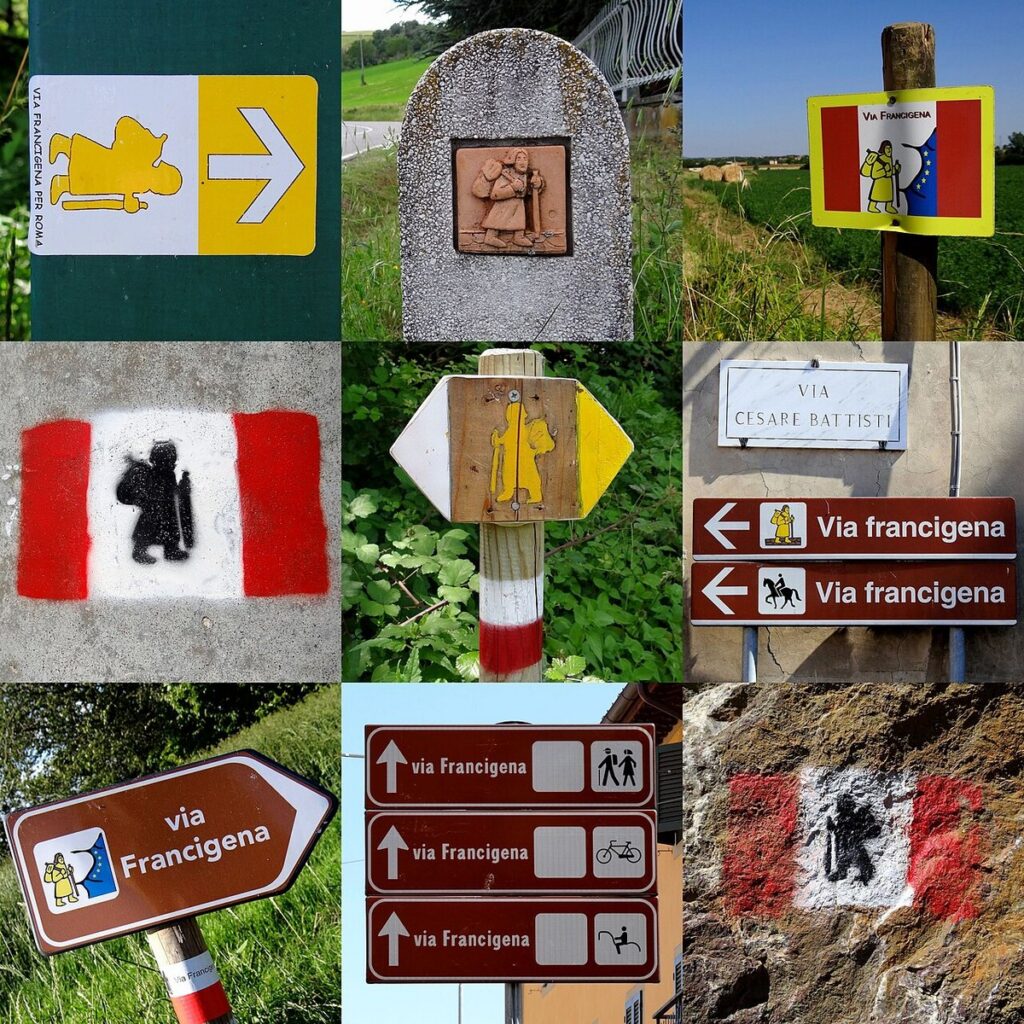 Diversi segnavia della Via Francigena con il pellegrino stilizzato, su cartelli, pali e rocce